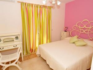 a bedroom with a bed and a desk with a microwave at Sami Beach Villas Fedra in Sami