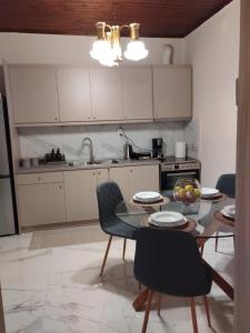 a kitchen with a table and chairs in a kitchen at Vagia in Tríkala