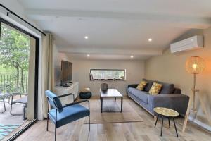 a living room with a couch and a tv at The Provencal Escape - Swimming Pool & Nature in Trets