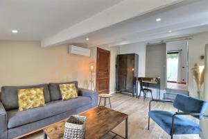 a living room with a couch and a table and a piano at The Provencal Escape - Swimming Pool & Nature in Trets