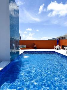 a swimming pool on the roof of a building at I-17 um Studio aconchegante in Maceió