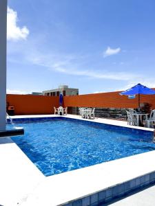 a swimming pool on the roof of a building at I-17 um Studio aconchegante in Maceió
