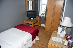 سرير أو أسرّة في غرفة في Caledonian Hotel