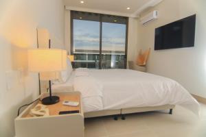 Ένα ή περισσότερα κρεβάτια σε δωμάτιο στο Exclusive Apartment With Ocean View By Huespedia +26 φωτογραφίες