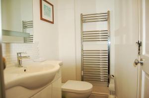 a white bathroom with a sink and a toilet at Cysgod Idris Cottage in Dolgellau +58 photos