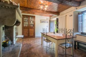 a kitchen with a table and chairs and a fireplace at Casa Storica a Pennabilli in Valmarecchia in San Marino Rustico +10 photos
