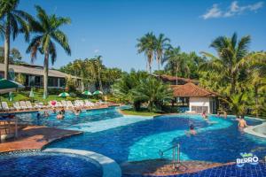 a pool at a resort with people in it at Hotel Berro D`Agua Eco Resort in Avaré