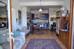 a living room with a couch and a kitchen at Villa Saha splendida dimora immersa tra gli ulivi in Itri +24 photos