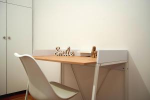 a desk in a room with a white chair at Superb New Family Apartment VIPGreece in Athens