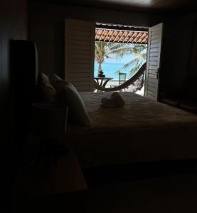 a bedroom with a bed with a view of the ocean at Pousada Beach House Coqueirinho in Jacumã +151 photos