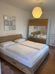 a bedroom with a large bed and a mirror at Ferienwohnung Simon in Freudenstadt
