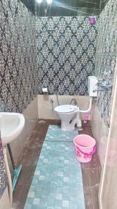 a bathroom with a toilet and a sink at Rudra The Stay in Jaipur +16 photos