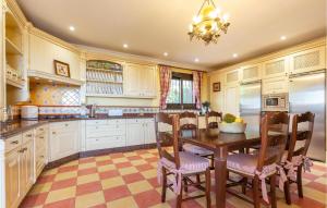 a kitchen with a wooden table and chairs at 6 Bedroom Awesome Home In Marbella in Marbella