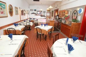 a dining room with tables and chairs in a restaurant at Hotel San Vitale in Medicina