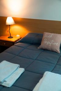a bed with a pillow with the words instant medicine on it at Los Fresnos in El Calafate