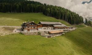 an aerial view of a large house in a field at Öbersthof Latzfons in Chiusa