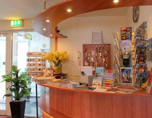 a shop with a counter with books on it at Hotel Kaiser in Berlin
