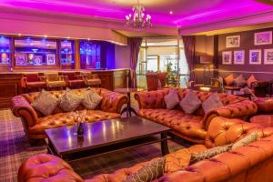 a living room with leather couches and a bar at Royal Bath Hotel Bournemouth in Bournemouth +36 photos