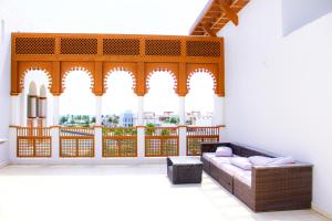a living room with a couch and a large window at Breathtaking Marina Views at Jebel Sifah in As Sīfah