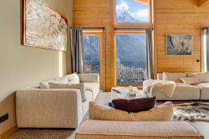 a living room with two couches and two windows at Chalet Ciscana Chamonix MontBlanc in Chamonix