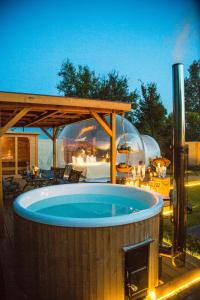 a hot tub in a backyard with a gazebo at Schloss Krugsdorf Golf & Hotel in Krugsdorf