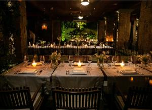 a long table with candles and plates and glasses at Awasi Santa Catarina in Governador Celso Ramos