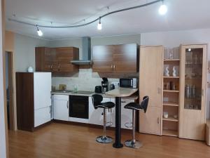 a kitchen with a table and some bar stools at Ferienwohnung Röddenau in Röddenau