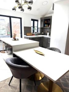 a kitchen with a white table and chairs at Rose home in Haverhill