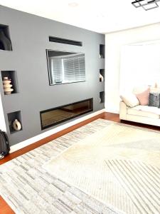 a living room with a fireplace and a couch at Rose home in Haverhill
