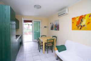 a kitchen and dining room with a table and chairs at Monolocale con terrazzo a Sirolo - S052 in Sirolo