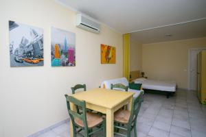 a room with a table and chairs and a bed at Monolocale con terrazzo a Sirolo - S052 in Sirolo