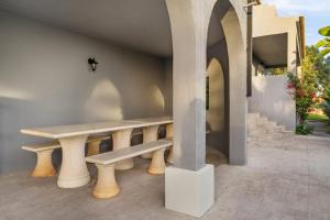 a table and a bench on a patio at Canaan Boutique Casa do Monte by Get Your Stay in Boliqueime