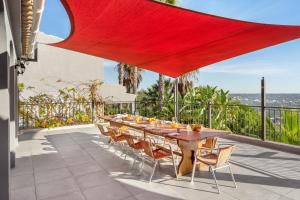 a long wooden table and chairs on a patio at Canaan Boutique Casa do Monte by Get Your Stay in Boliqueime