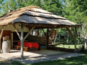 a large hut with a red table in it at Bosque Hermoso in San Rafael