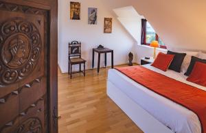 a bedroom with a large bed with a wooden door at Villa Kermohic - en front de mer in Pleubian