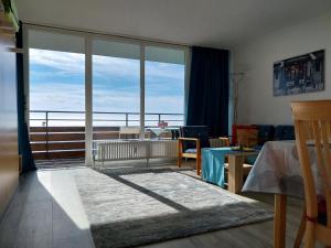 a living room with a large window with a view at Ferienwohnungen Adri im Ferienpark Geyersberg in Freyung