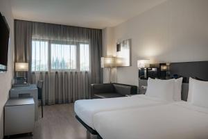 A bed or beds in a room at AC Hotel Atocha by Marriott