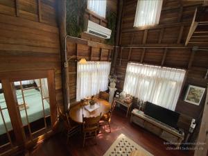 an overhead view of a dining room with a table and a television at Luxury Treehouse Khaoyai in Ban Nong Makha