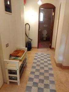 a hallway with a room with a table and a toilet at Down-Town Kafr El Gouna 1-Bd Ground Floor in Hurghada