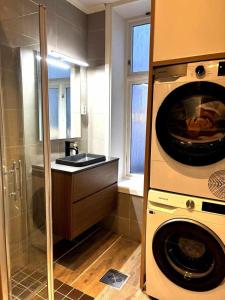 a kitchen with a washing machine and a sink at Central and modern in Oslo