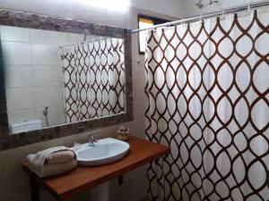a bathroom with a sink and a shower with a mirror at La Araucana in Tacuarembó +44 photos