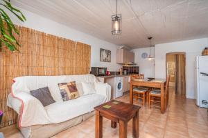 a living room with a couch and a table at Casa da Praia 2 in Budens +17 photos