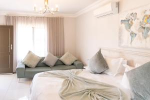 a bedroom with a bed and a couch at Prisatt Boutique Hotel in Onverwacht +73 photos