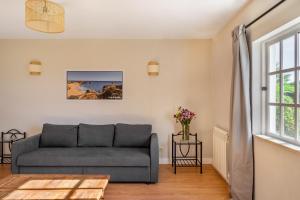 a living room with a couch and a window at Canaan Boutique Casa do Monte by Get Your Stay in Boliqueime