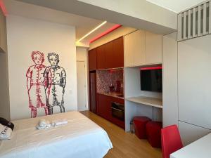 a small room with a bed and a tv at TrevizZo Vergueiro in São Paulo +30 photos