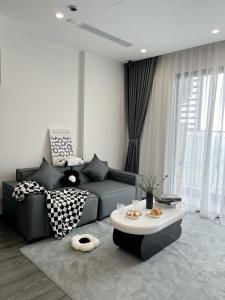 a living room with a couch and a table at Bunnys Homes - Service Apartment in Gia Lâm Pho