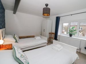 une chambre avec deux lits et une fenêtre dans l'établissement La Bastille, à Haverfordwest