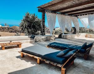 a bed sitting on top of a patio at Etherea - I Dammusini di Pantelleria in Pantelleria