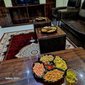a room with two tables with plates of food at Luxury Living in Kabul in Kabul