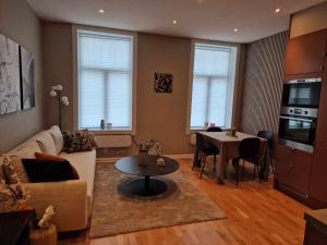 a living room with a couch and a table at Central and modern in Oslo
